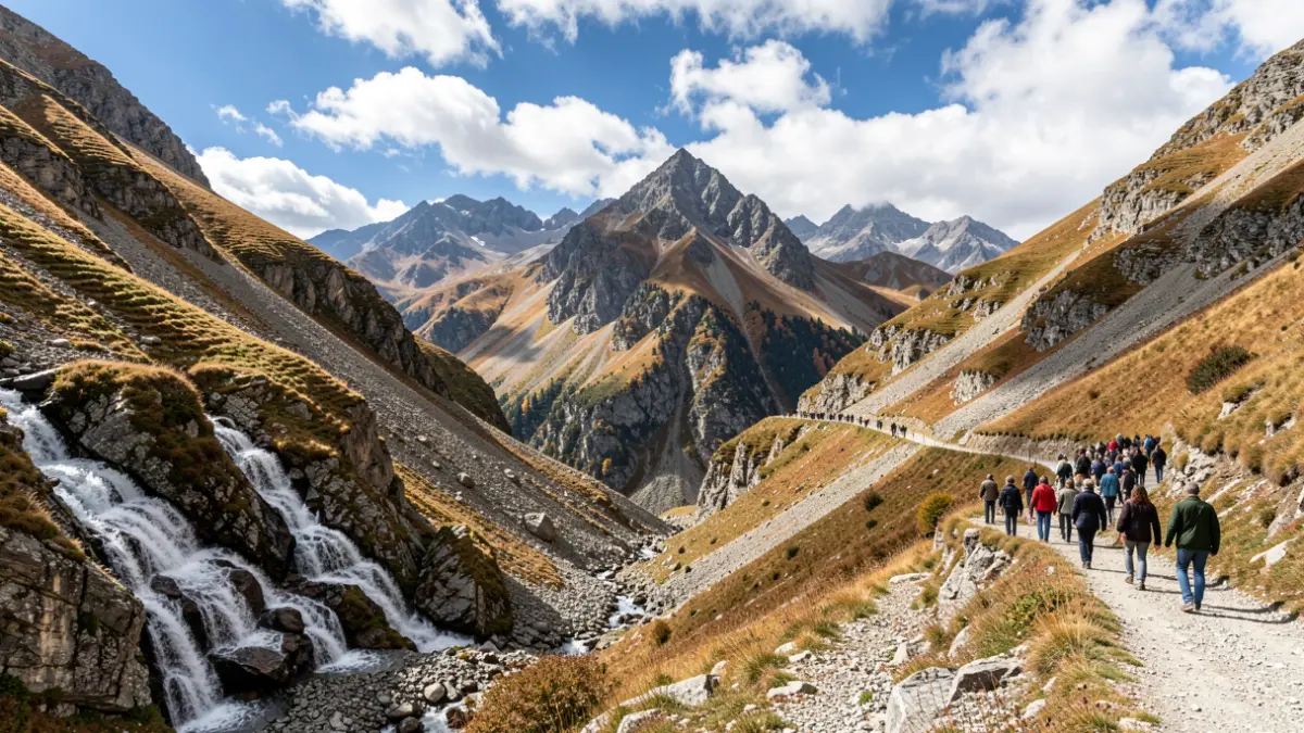 Paysage de montagne dans les Hautes-Alpes avec un sentier, un torrent et des formations rocheuses sous un ciel d'automne.